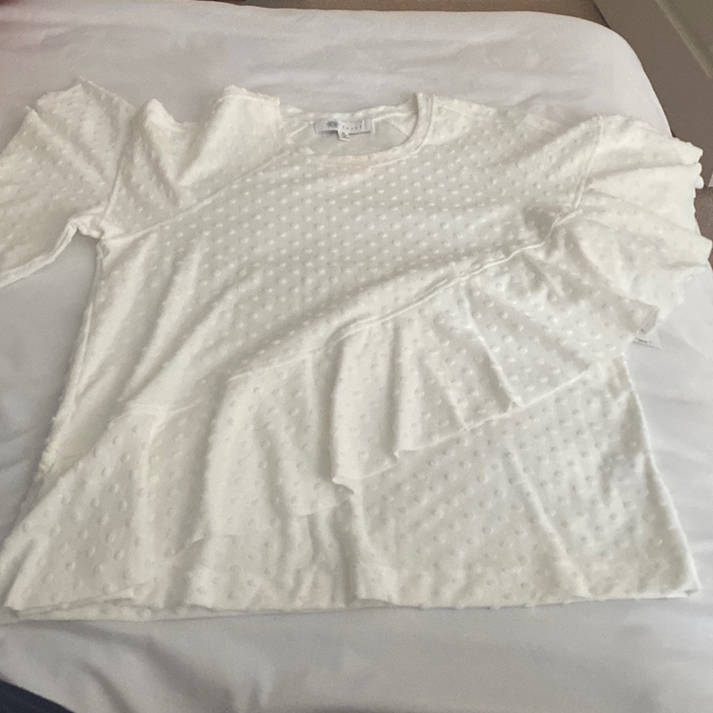 White Swiss dot T-shirt with a flutter detail and bell sleeves